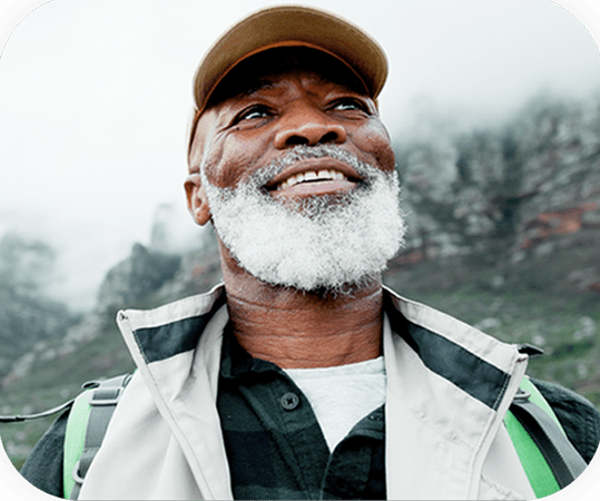 Elderly man smiling with hat