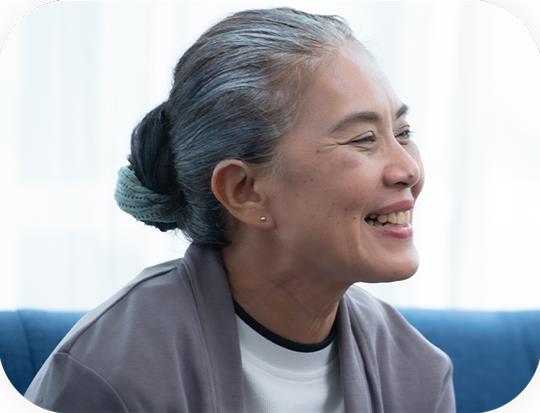 Elderly woman smiling with hair in a bun